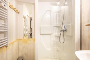 a bathroom with a shower and a toilet and a sink at Le Freeride - 14ème étage avec vue sur montagne in Villarembert