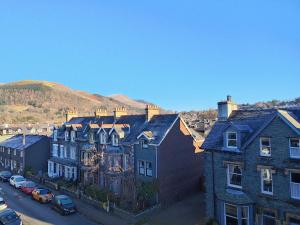 a group of houses with cars parked in a street at Squirrel Lodge in Keswick