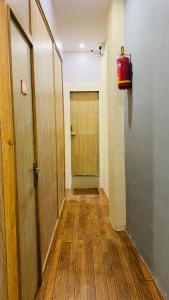an empty hallway with a door and a fire extinguisher at Casa Cabin Stay Mumbai in Mumbai