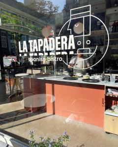 a store window with a sign that reads la taparcariaaranticismdefine at the bellhop in Rotterdam