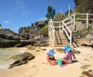 two little girls playing in the sand on the beach at Willowbank Resort in Somerset