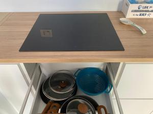 a drawer with some plates and pans on a table at Da Nord a Sud - Polonia 21 Loft in Termoli
