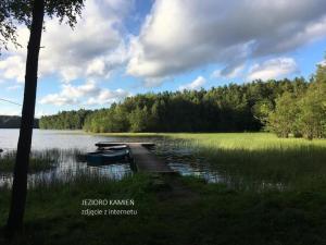 a dock on a lake with two boats on it at high-Q in Kowalewo