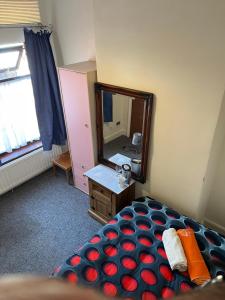 a bedroom with a large mirror and a bed at Quite Broad Rest 5 in Longford