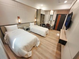 Postel nebo postele na pokoji v ubytování Gucheng International Hotel