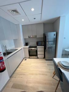 a kitchen with white cabinets and stainless steel appliances at Waters edge in Abu Dhabi