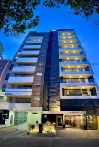 a tall building with lights in front of it at Apartamentos Gema by Cadissa in Medellín