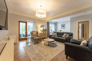 una sala de estar con un sofá y una mesa en The Lindsay House, en Stirling