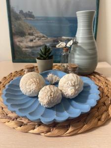 a tray with blue plates and a vase on a table at Sea Garden Beach Studio in Saints Constantine and Helena