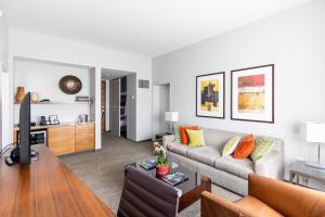 a living room with a couch and a table at I Hotel and Illinois Conference Center - Champaign in Champaign