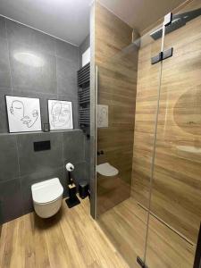 a bathroom with a toilet and a shower at ECRU Port Praski Stylish Apartment near Old Town WWA33 in Warsaw