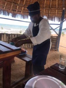 a man standing in front of a table at MHALO BEACH LODGE 