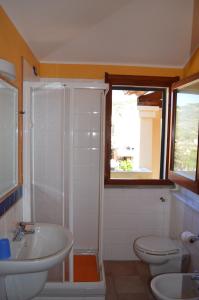 a bathroom with a sink and a toilet and a shower at Chia Holiday Home in Chia