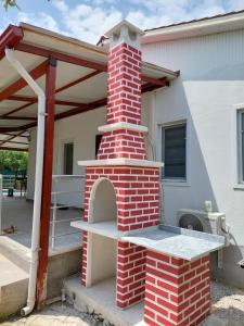 an outdoor brick oven in front of a house at Avci Villa-Fethiye 3+1 in Garden with Private Pool, 10 minutes to the beach in Fethiye