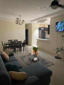 a living room with a couch and a dining room at Catch a Vibes Bolt! - Ocho Rios in Ocho Rios