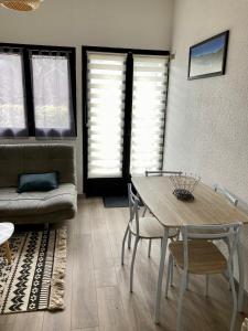 a living room with a table and a couch at Petite maison VILLEFORT in Villefort