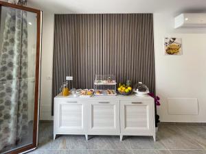 a white cabinet with food on it in a room at Ad Maiora B&B in San Vito lo Capo