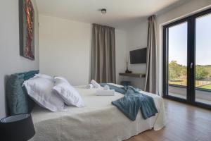 a bedroom with a bed and a large window at Arestea in Vodnjan +57 photos