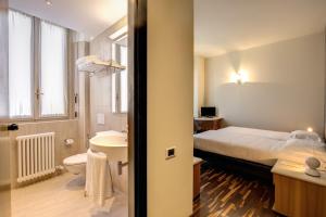 Una cama o camas en una habitación de Albergo Firenze
