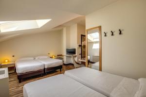 Una cama o camas en una habitación de Albergo Firenze