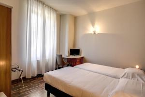 Una cama o camas en una habitación de Albergo Firenze
