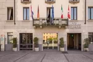 a building with flags in front of it at Albergo Firenze in Como