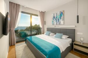 a bedroom with a bed and a large window at Anabel in Hvar