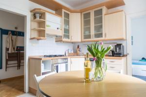 a kitchen with a table with a bottle of wine at Apartmán U Šálků in Znojmo +9 photos