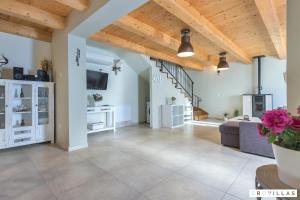 a large living room with a couch and a staircase at Ive in Orbanići