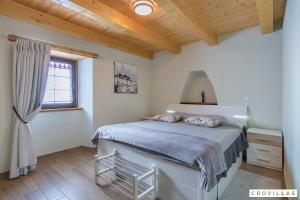 a bedroom with a bed and a wooden ceiling at Ive in Orbanići +35 photos