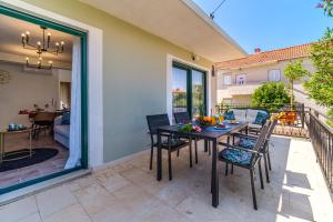 a patio with a table and chairs on a balcony at Josipa in Supetar