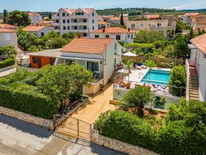 a house with a swimming pool in a city at Josipa in Supetar