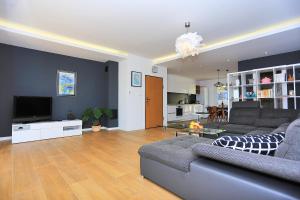 a living room with a couch and a tv in it at Karmen Adriatica in Kukljica