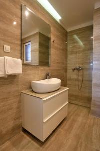 a bathroom with a sink and a mirror at Karmen Adriatica in Kukljica