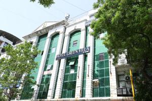 a building with a sign on the side of it at HOTEL GREEN VILLA in Surat