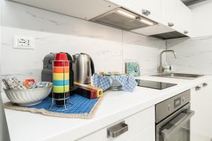 a kitchen counter top with a sink and a kitchen appliance at Sea Loft Quinto - A due passi dal mare in Genoa