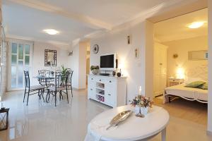 a large living room with a bed and a table at La Perla in Cavtat