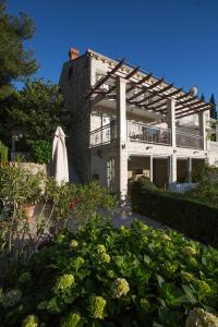 a building with a bunch of plants in front of it at La Perla in Cavtat