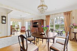 a dining room with a table and chairs at Villa Muusa in Tallinn