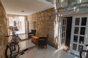 a room with a stone wall with a bike in it at Joe in Čilipi