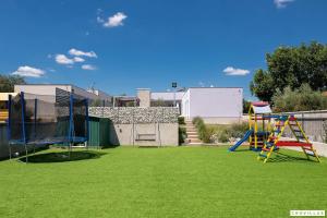 a yard with a playground with a slide at Lavanda-labin in Veli Turini