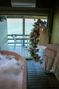 a bath tub in a room with a view of the ocean at ForYou OtuzBeş in Izmir