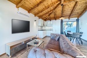 a living room with a couch and a flat screen tv at Lux Ii in Murter