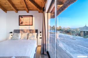 a bedroom with a bed and a large window at Lux Ii in Murter +9 photos