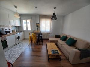 a living room with a couch and a table at El Pisuco de Lu entre Puertochico y El Sardinero in Santander