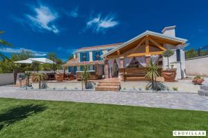 een huis met een tuinhuisje in een tuin bij Mek in Pridraga