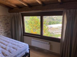 1 dormitorio con cama y ventana grande en Gli Orti dei Doria di dolceacqua en Dolceacqua