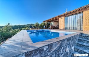 a swimming pool in a house with a stone wall at Lux I in Murter