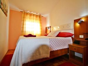 a bedroom with a bed and a window at AP Silvija in Zadar