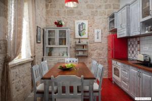 a kitchen with a table and chairs and a red refrigerator at Vis in Vis